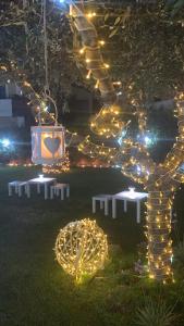 un giardino con luci e tavoli in un cortile di Villa Mascitti B&B a Tortoreto