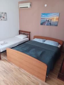 a bedroom with two beds and a fan at Apartmany Makarská in Drvenik