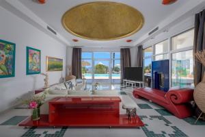 a living room with a couch and a tv at Grande Dame Villa of Rhodes in Rhodes Town