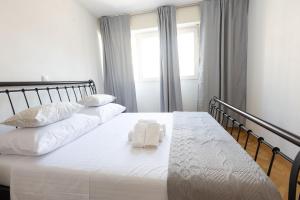 a bedroom with a bed with two towels on it at Apartment Srecko in Omiš