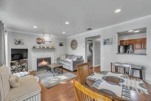 a living room with a table and a fireplace at Nash Gold Condo, 20min Walk to Downtown, 2Bd,2Bth in Nashville