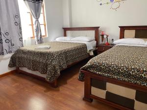 Postel nebo postele na pokoji v ubytování Hostal Arauco