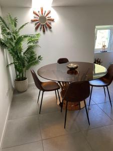 a dining room with a table and chairs and a plant at Mountain View 