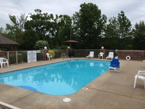 a large swimming pool with chairs and a gazebo at Americas Best Value Inn Cabot in Cabot
