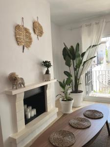a living room with a fireplace and a table at Boutique apartment 365 - Marbella in Marbella