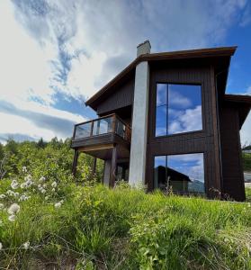a house on top of a grassy hill at Exclusive Suite in the Sunnmøre Alps, Near Geiranger & Hjørundfjord in Stranda