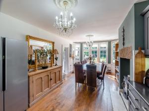 a dining room with a table and chairs and a chandelier at Bridgegate House in Belper