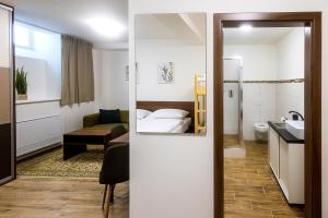 a hotel room with a bed and a bathroom at Old Town Hall - Stará radnice - Ratusz Staromiejski in Bohumín