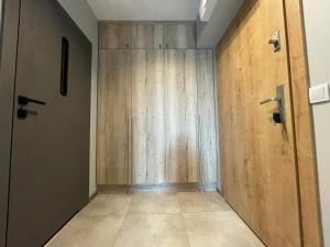 a hallway with a wooden wall and a door at APT. 539 in Dziwnówek +18 photos