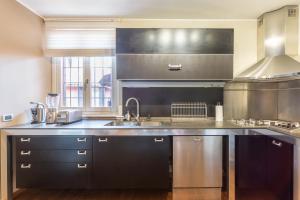 a kitchen with a sink and a counter top at Suite Alzaia by iCasamia it in Milan +24 photos