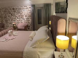 a bedroom with a bed and a brick wall at Private Apartments In Diocletians Palace in Split