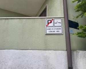 a sign on the side of a building that says save at at Tulip in Ližnjan