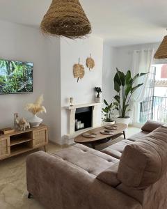 a living room with a couch and a fireplace at Boutique apartment 365 - Marbella in Marbella