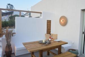 a room with a wooden table and a chair at Lipsi Sands in Lipsoi