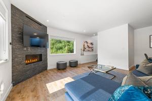 a living room with a couch and a fireplace at Fabulous Beach Get Away - Brand New Beach House in Half Moon Bay