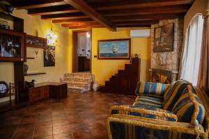a living room with a couch and a fireplace at La Dimora del Cavaliere - Stupenda Dimora a 5 Min Dal Lago di Martignano in Anguillara Sabazia