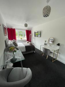 um quarto com uma cama, uma secretária e uma cadeira em Large Stylish 2 Bedroom Apartment Stevenage Sleep 6 em Stevenage