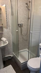 a bathroom with a shower with a toilet and a sink at L’ESPERANCE in Versailles