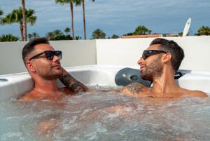 two men wearing sunglasses in a hot tub at MAR BIANCO - Gay Men Only in Maspalomas