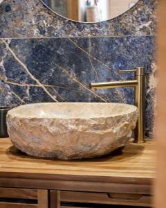 a bathroom with a stone sink and a mirror at Appartement le Quai du Port Cassis parking clim in Cassis