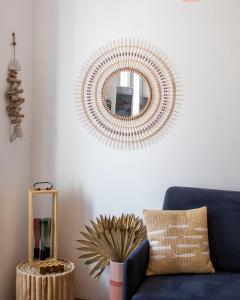 a living room with a blue couch and a mirror at Appartement le Quai du Port Cassis parking clim in Cassis