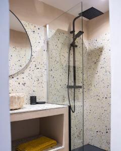 a shower with a glass door in a bathroom at Endoume Notre Dame de la Garde T2 avec PARKING in Marseille