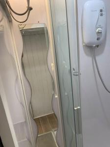 a glass door on a train with a phone at One bedroom apartment in heart of brighton in Brighton & Hove
