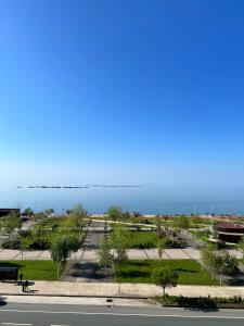 a view of a park with the ocean in the background at Rosella Royal Suit - روزيلا رويال in Arsin