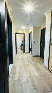 an empty hallway of an apartment with wooden floors at Rosella Royal Suit - روزيلا رويال in Arsin