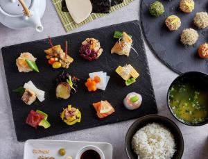 a plate of food with sushi and rice on a table at 203 Oshiage sta 3mins walk! Wi-Fi Elevator 4pax in Tokyo
