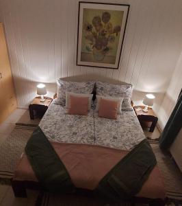 a bedroom with a large bed with two pillows at Jókai Vendégház in Egerszalók