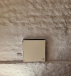 a metal box on a concrete wall at Los tarcos Guest House LOFT TILCARA in Tilcara