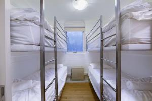 two bunk beds in a room with a window at Snow Ski Apartments 30 in Falls Creek