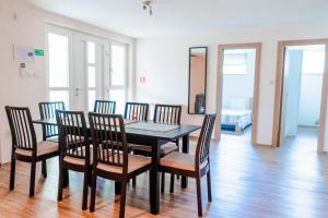 a dining room with a black table and chairs at Villa Livi - Luxury sea view appartments in Medulin
