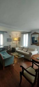 a living room with a couch and a table at Vintage House by the Sea in Chorefto