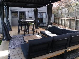 a backyard patio with a couch and a table at Lake Taupo Holiday Home in Taupo