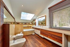 a bathroom with a sink and a tub and a toilet at Das Gsteig in Garmisch-Partenkirchen +43 photos