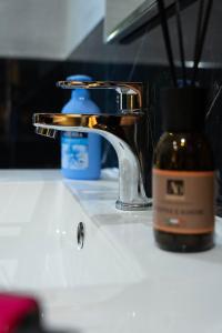 a sink with a faucet and a bottle of soap at Lovely homes in Genoa