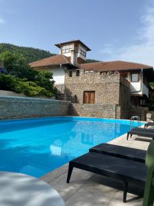 a swimming pool in front of a house at Heritage Home Ustikolina in Foča