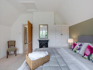 a white bedroom with a large bed and a fireplace at Bridgegate House in Belper