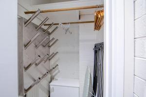 a bathroom with a toilet and a white wall at Snow Ski Apartments 23 in Falls Creek +7 photos