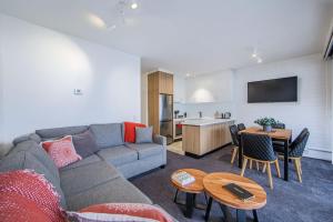 a living room with a couch and a table at Snow Ski Apartments 23 in Falls Creek