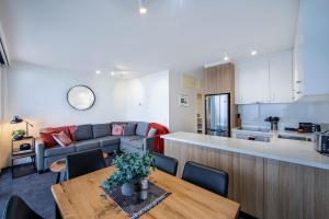 a living room and kitchen with a table and a couch at Snow Ski Apartments 23 in Falls Creek