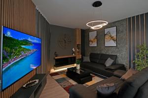 a living room with a large flat screen tv at CLOVER - Moonlight in Sarajevo