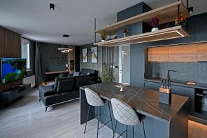 a kitchen and living room with a bar and a couch at CLOVER - Moonlight in Sarajevo