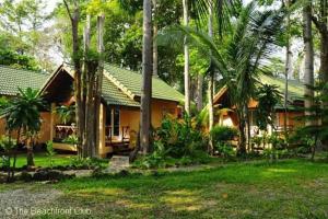 a house with a green roof and palm trees at Paradise Palms in Ko Chang