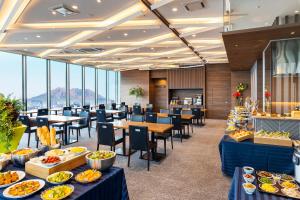 a restaurant with tables and chairs with food on them at Hotel Gran Cerezo Kagoshima in Kagoshima