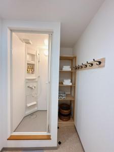 a bathroom with a shower and a walk in closet at 三米-黒門市場-黑门市场-kuromon 202タイプ in Osaka