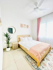 a white bedroom with a bed and a window at House10 Desaru Coast with KTV BBQ Private Pool in Bandar Penawar +12 photos
