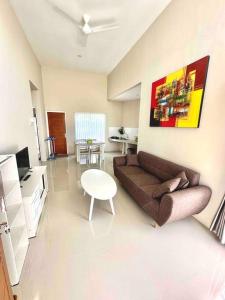 a living room with a couch and a table at Batujai House in Praya